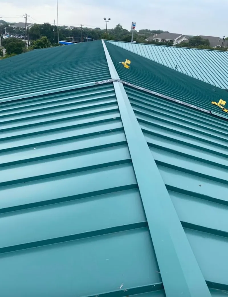 Green commercial metal roof ridge and valley for Metal Roof Repair in Indianola